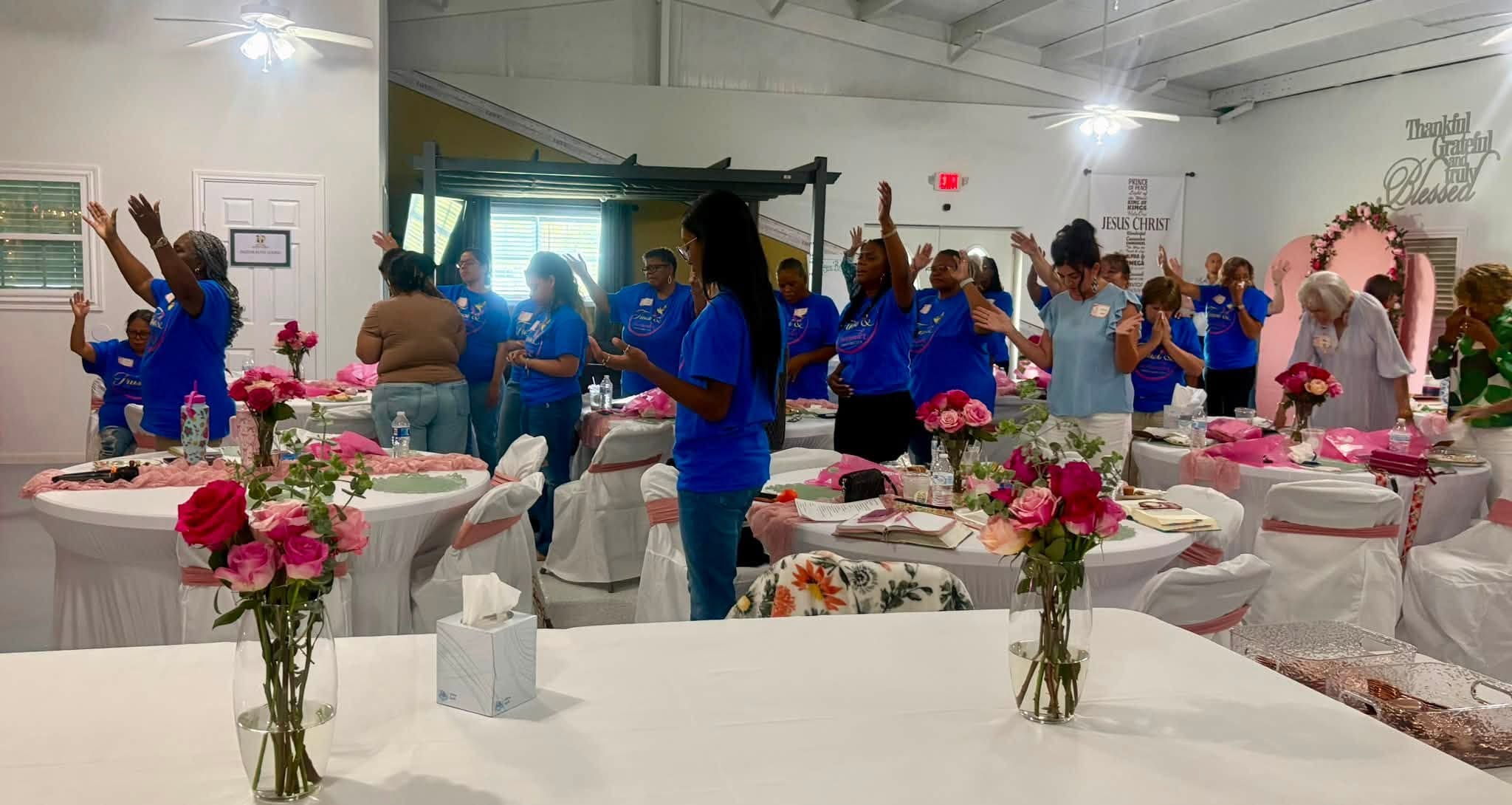 Women worshiping together at Agape Family Outreach Church